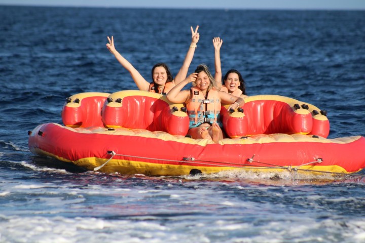 a group of people in a small boat in a body of water