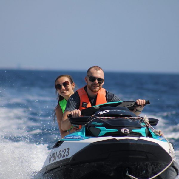 a man riding a wave on a surf board on a body of water