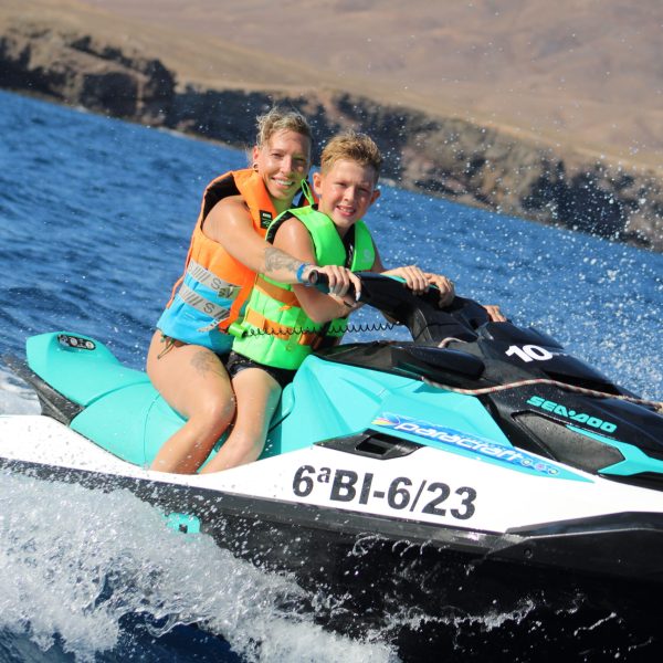 a girl riding a wave on a surf board on a body of water