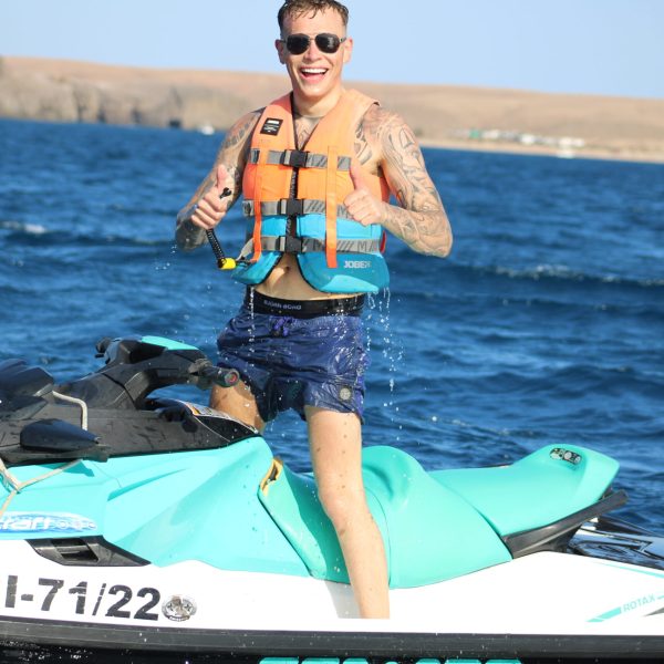 a person standing next to a body of water