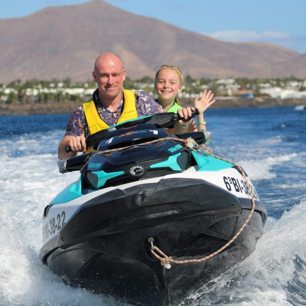 a man riding on the back of a boat in a body of water