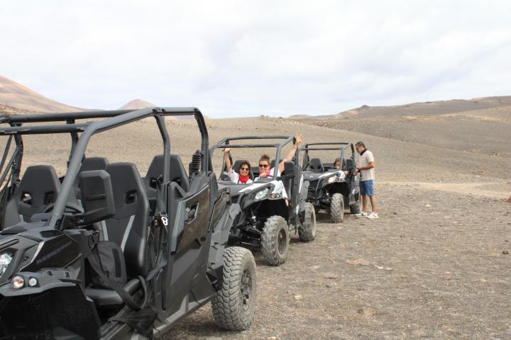 a group of people riding on the back of a truck