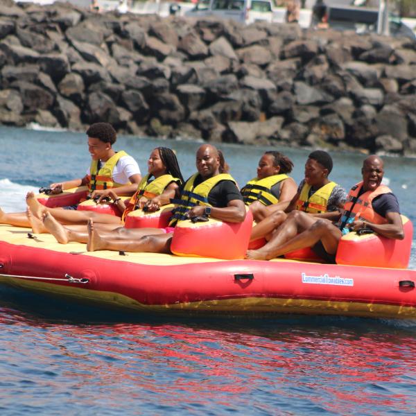 a group of people in a small boat in a body of water