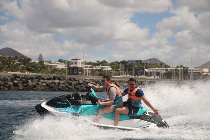 a young girl riding a wave on a surfboard in the water