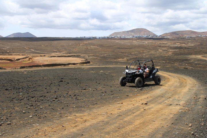 a person riding a motorcycle down a dirt road
