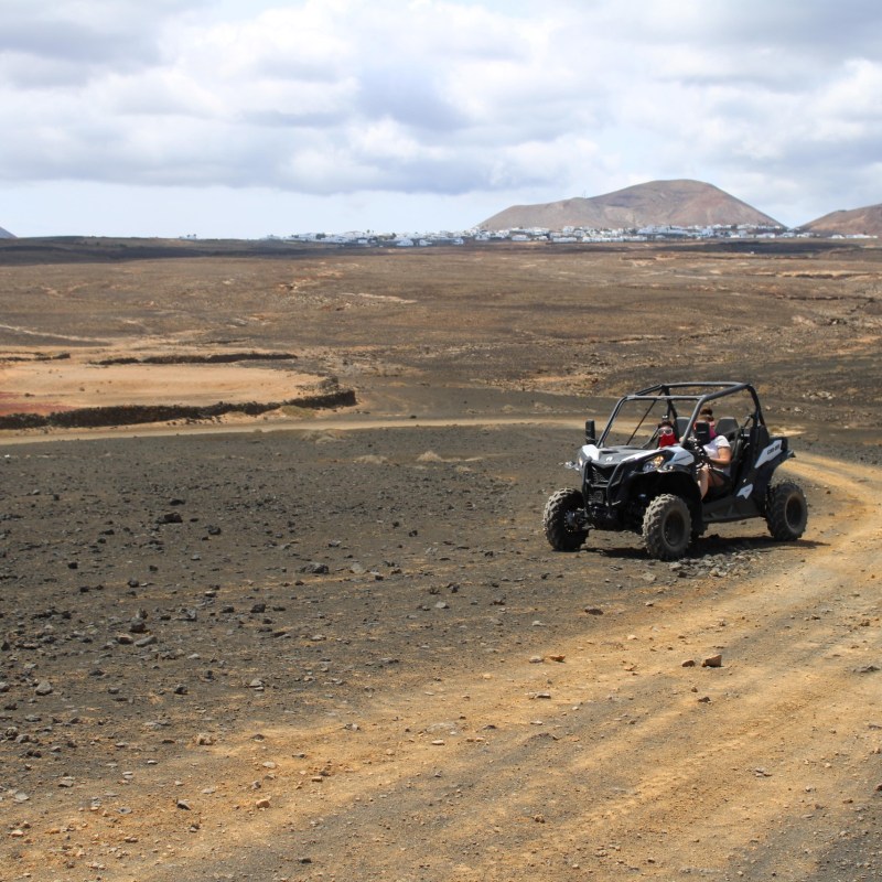 a person riding a motorcycle down a dirt road