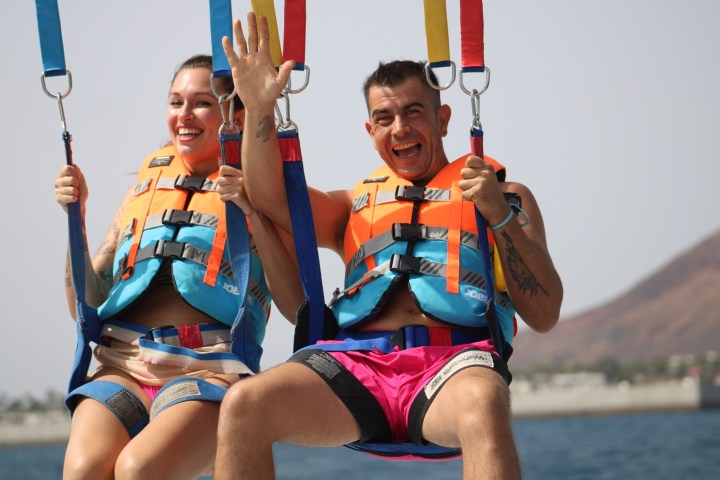 a woman standing next to a body of water