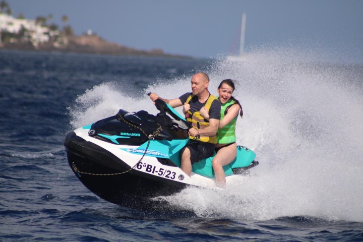 a man riding a wave on a surf board on a body of water